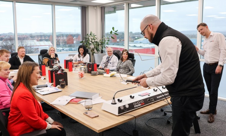 Guests around a table playing with buzz wire